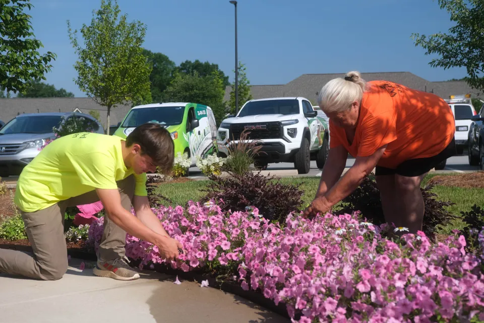 Landscape maintenance crew finishing turf and bed work