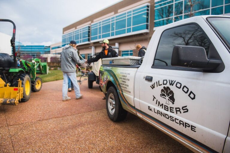 Wildwood Landscapes branded timber sign at a commercial property.